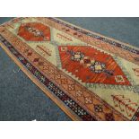 A Turkish woollen geometric patterned runner in blue & orange ground, 2.24m long