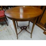 An antique inlaid mahogany two-tier oval occasional table