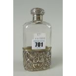 A Victorian silver mounted faceted glass hip flask with raised foliate decoration and cartouche,