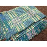 A blue & green geometric patterned Welsh blanket