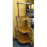 An antique burr walnut four-tier whatnot with shaped shelves and turned supports
