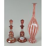 A Venetian striped glass bottle vase, 34cms high and a pair of red and clear glass fancy bell-shaped