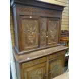 A continental carved cupboard-dresser, 124cms wide