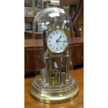 A vintage brass and glass domed perpetual clock