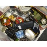Two tins of collectables including military-type badges, miniature binoculars, trinkets ETC