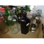 A collection of green and clear glass vintage pharmacy bottles ETC