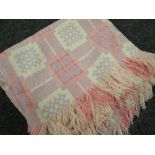 A pink and cream geometric patterned Welsh blanket