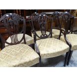 A set of six antique mahogany dining chairs (5+1) with matching floral upholstered seats
