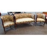 An antique / vintage three-piece floral upholstered antique tub-style suite comprising two armchairs