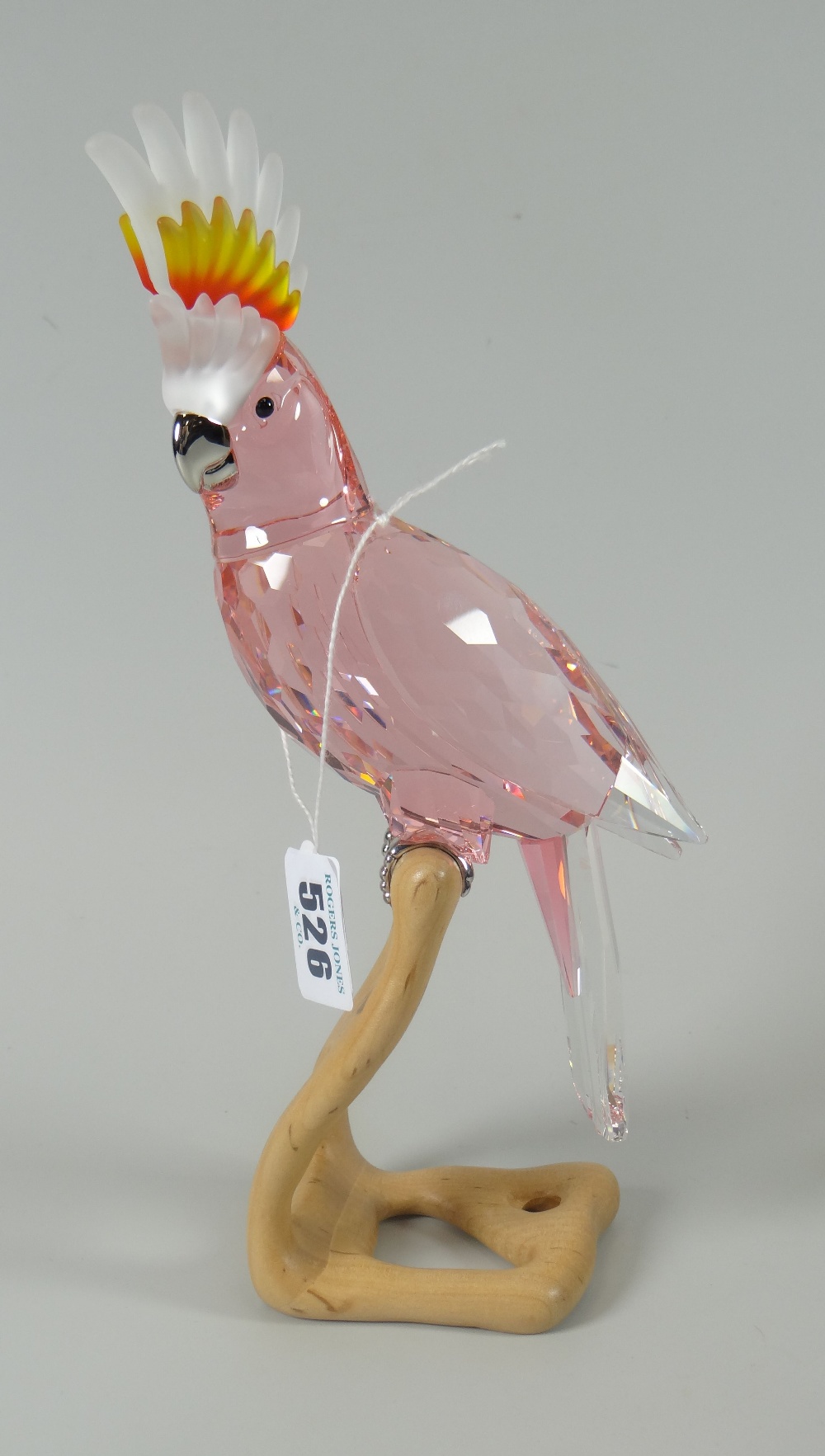 Swarovski crystal glass 'Paradise Bird' red / pink cockatoo on naturalistic wooden base, 24cms