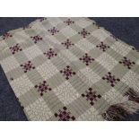 A pale green and plum geometric Welsh blanket