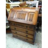 An oak Old Charm drop down bureau with a four-drawer base