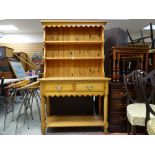 A modern pine dresser with two drawers and lower shelf and open rack, 101cms wide and a nest of