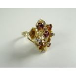 14 CARAT YELLOW GOLD RING set with small rubies and two tiny diamond chips in an abstract form 10
