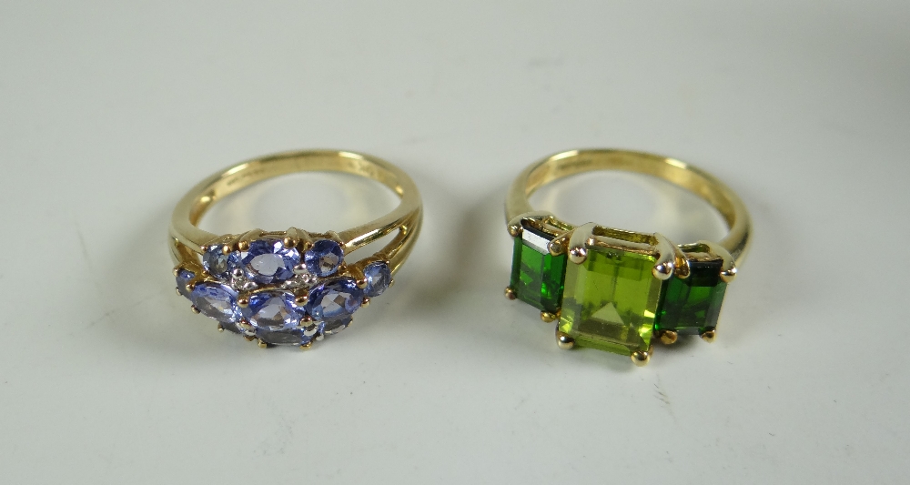 TWO NINE CARAT GOLD RINGS, one with peridot, the other with tanzanite