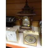 A BRASS FACED WOODEN CASED MANTEL CLOCK together with two others