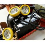 THREE MINERS/FIREMENS HELMET LAMPS, together with battery packs