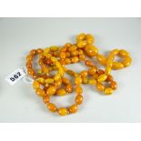 AMBER two strands of butterscotch amber beads, one graduated and 70cms long and the (darker) of