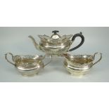 GEORGE V THREE-PIECE SILVER TEASET comprising teapot, sucrier and cream jug, all with pierced scroll