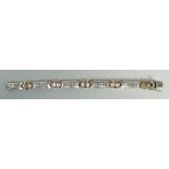 14K WHITE AND ROSE GOLD DIAMOND BRACELET set with 70 round cut brilliant diamonds, 21cms long, 51