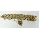 9CT YELLOW GOLD LADIES BRACELET WITH HEART SHAPED PADLOCK. 33.2 grams approximately. Condition