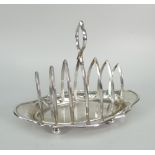 GEORGE V SILVER SIX SECTION TOAST RACK OF OVAL FORM raised on four ball feet with loop handle.