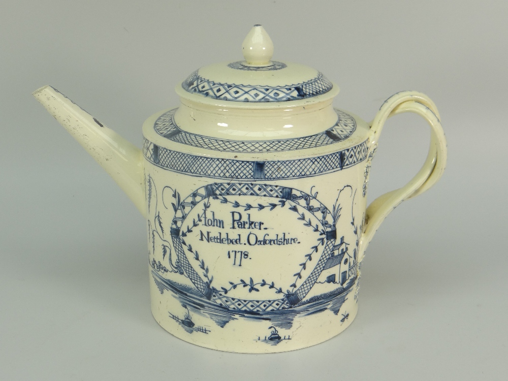 AN EIGHTEENTH CENTURY CREAMWARE OVERSIZE TEAPOT decorated with underglazed blue landscape decoration