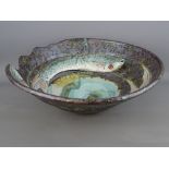 A ROGER COCKRAM 34.5 cms DIAMETER PIERCED STONEWARE BOWL with incised fish decoration, one with head