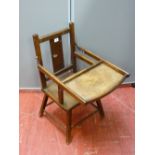 A vintage oak child's seat with foldover tray, 68 cms high