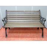 A wooden slatted bench with cast iron ends