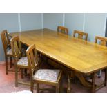 A reproduction oak twin pedestal dining table, 238 cms long (shrinkage splits to top) and six