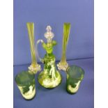 Green glass decanter and two beakers, decorated Mary Gregory style and a pair of long stemmed vases
