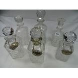 Six cut and other glass decanters with stoppers, some with labels