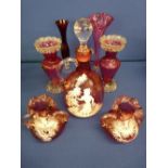 Cranberry glass decanter with stopper and a pair of frilly top vases decorated Mary Gregory style, a