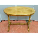 A Victorian walnut side table with floral inlay on carved and turned supports with cross stretcher