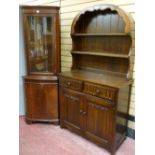 A glass top reproduction corner cabinet and a Priory style dresser