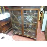 Circa 1900 glass front mahogany bookcase having twin thirteen pane astragal glazed doors and