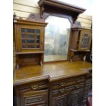 Edwardian breakfront mirror back sideboard having a carved front, four drawers and four cupboard