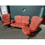 Mid Century Ercol stick back three piece lounge suite of two seater couch and a pair of armchairs,