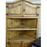 Rough pine standing corner cupboard, possibly Continental, having a domed top with two high