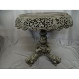 Burmese carved tilt top occasional table on tripod dragon decorated supports, 56 cms diameter