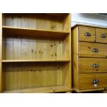 Modern pine open bookcase and a similar narrow chest of five drawers