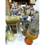 Three vintage oil lamps, a brass paraffin lamp and a collection of modern Oriental pottery table