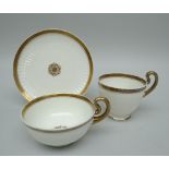 A SWANSEA PORCELAIN PARIS FLUTE TRIO with gilding and centred floral motif, stencilled SWANSEA