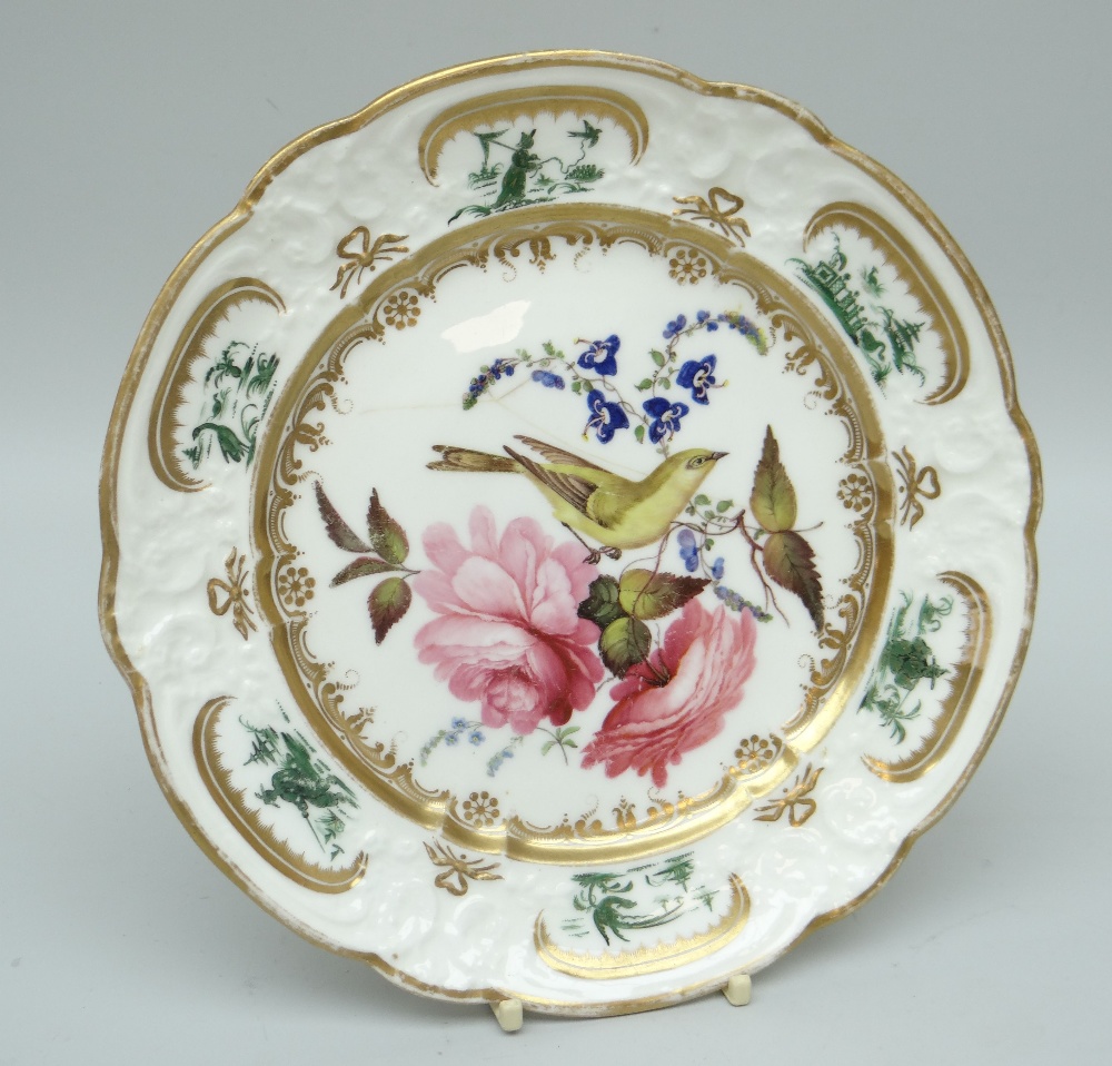 A RARE NANT GARW PORCELAIN DESSERT PLATE decorated with a centred bird (intriguingly with human-