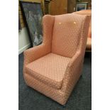 A GOOD VINTAGE WING-BACK ARMCHAIR having fan patterned pink upholstery