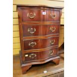 A GOOD REPRODUCTION SERPENTINE FRONT SMALL CHEST of four drawers with brass handles