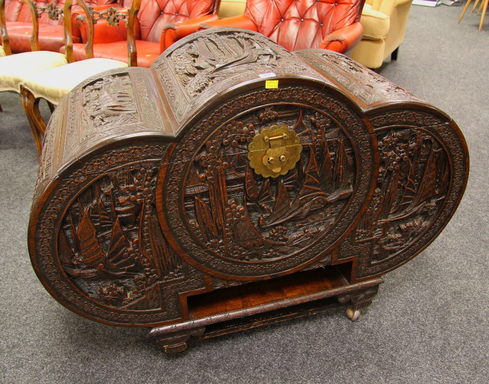 A GOOD CAMPHORWOOD ORIENTAL CHEST of tri-form and having deeply carved panels depicting sailing