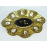 AN ITALIAN GILT METAL DISH of flared form and bejewelled with a series of eight cameos to the border