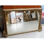 A FANCY PAINTED AND GILDED OVERMANTEL MIRROR